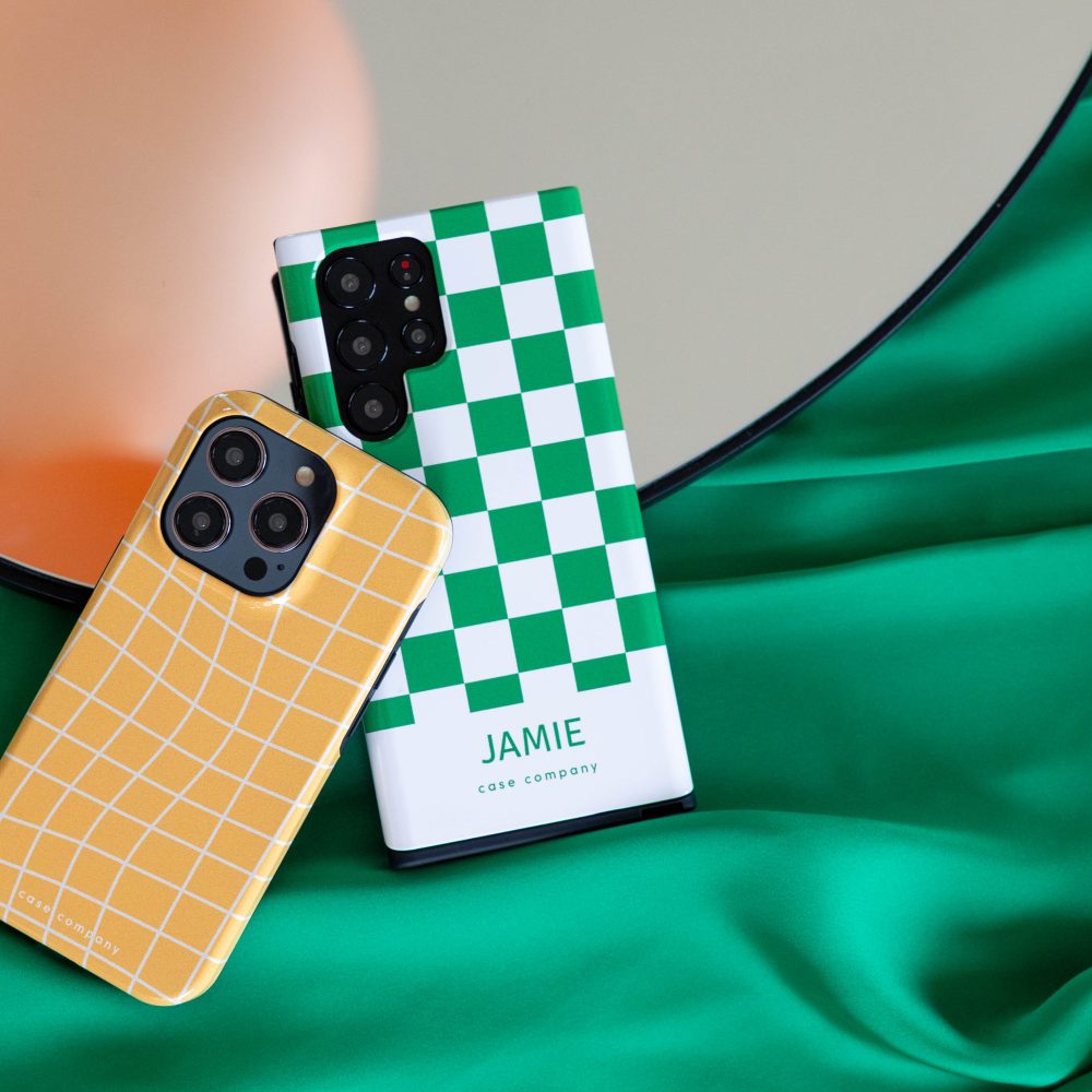 Two tough cases: a yellow plaid one for iPhone and a green checked one with the name Jamie